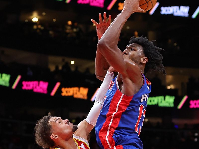 ATLANTA, GEORGIA - DECEMBER 18:  James Wiseman #13 of the Detroit Pistons draws a foul from Trae Young #11 of the Atlanta Hawks during the fourth quarter at State Farm Arena on December 18, 2023 in Atlanta, Georgia.  NOTE TO USER: User expressly acknowledges and agrees that, by downloading and/or using this photograph, user is consenting to the terms and conditions of the Getty Images License Agreement.  (Photo by Kevin C. Cox/Getty Images)