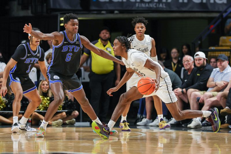 Feb 1, 2025; Orlando, Florida, USA; UCF Knights guard Tyler Hendricks (15) drives to the basket against Brigham Young Cougars forward Kanon Catchings (6) during the second half at Addition Financial Arena. Mandatory Credit: Mike Watters-Imagn Images