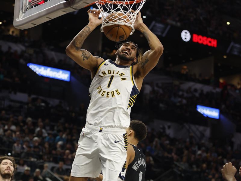 SAN ANTONIO, TX - MARCH 03: Obi Toppin #1 of the Indiana Pacers dunks past Victor Wembanyama #1 of the San Antonio Spurs in the first half at Frost Bank Center on March 3, 2024 in San Antonio, Texas. NOTE TO USER: User expressly acknowledges and agrees that, by downloading and or using this photograph, User is consenting to terms and conditions of the Getty Images License Agreement. (Photo by Ronald Cortes/Getty Images)