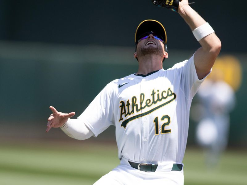 Jul 24, 2024; Oakland, California, USA; Oakland Athletics shortstop Max Schuemann (12) makes a catch on a popup by Houston Astros designated hitter Yordan Alvarez during the fifth inning at Oakland-Alameda County Coliseum. Mandatory Credit: D. Ross Cameron-USA TODAY Sports