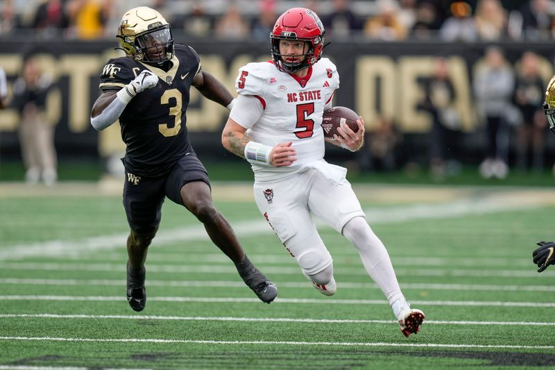 Nov 11, 2023; Winston-Salem, North Carolina, USA;  North Carolina State Wolfpack quarterback Brennan Armstrong (5) tries to outrun Wake Forest Demon Deacons defensive back Malik Mustapha (3) during the first half at Allegacy Federal Credit Union Stadium. Mandatory Credit: Jim Dedmon-USA TODAY Sports