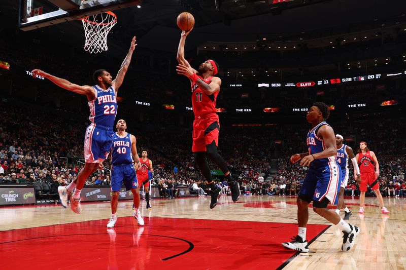 TORONTO, CANADA - MARCH 31: Bruce Brown #11 of the Toronto Raptors drives to the basket during the game against the Philadelphia 76ers on March 31, 2024 at the Scotiabank Arena in Toronto, Ontario, Canada.  NOTE TO USER: User expressly acknowledges and agrees that, by downloading and or using this Photograph, user is consenting to the terms and conditions of the Getty Images License Agreement.  Mandatory Copyright Notice: Copyright 2024 NBAE (Photo by Vaughn Ridley/NBAE via Getty Images)