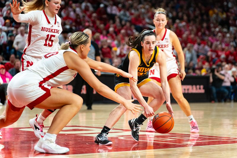 Feb 11, 2024; Lincoln, Nebraska, USA; Iowa Hawkeyes guard Caitlin Clark (22) scrambles for the ball against Nebraska Cornhuskers center Alexis Markowski (40) during the fourth quarter at Pinnacle Bank Arena. Mandatory Credit: Dylan Widger-USA TODAY Sports