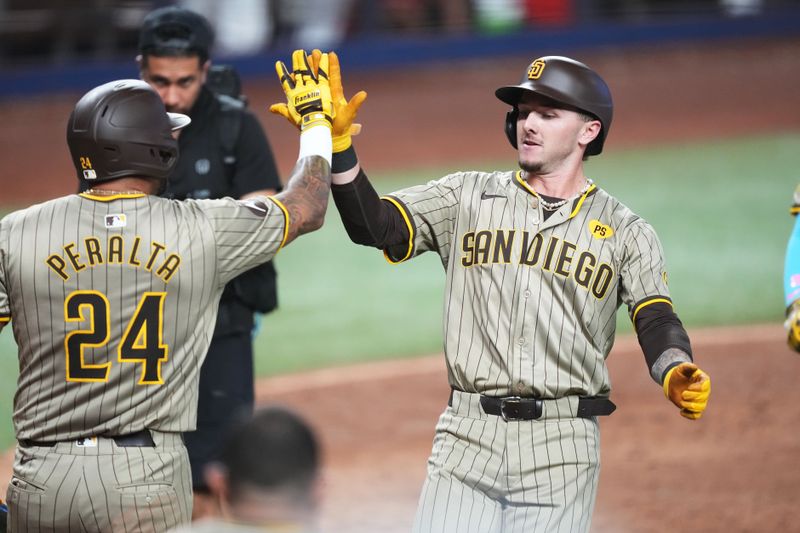 Aug 10, 2024; Miami, Florida, USA;  San Diego Padres right fielder David Peralta (24) congratulates center fielder Jackson Merrill (3) on a two-run home run in the eighth inning against the Miami Marlins at loanDepot Park. Mandatory Credit: Jim Rassol-USA TODAY Sports