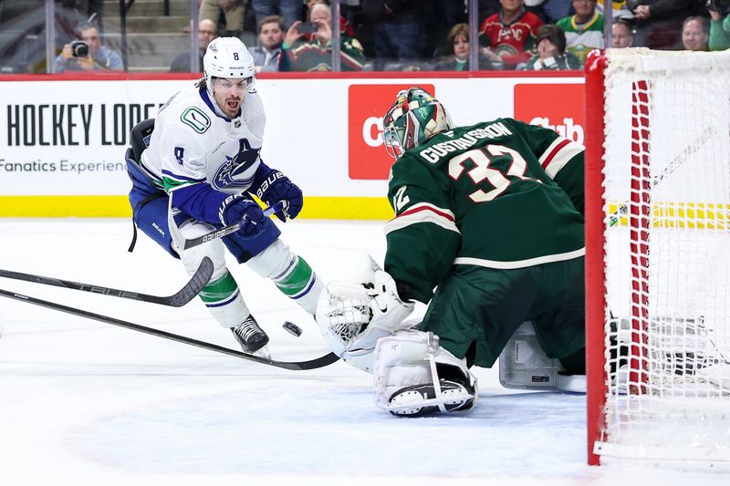 Dec 3, 2024; Saint Paul, Minnesota, USA; Minnesota Wild goaltender Filip Gustavsson (32) makes a save on a shot by Vancouver Canucks right wing Conor Garland (8) during overtime at Xcel Energy Center. Mandatory Credit: Matt Krohn-Imagn Images