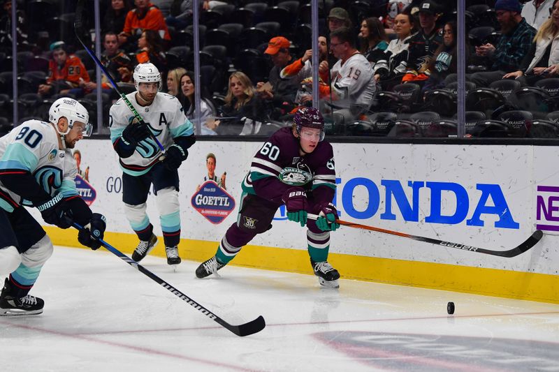 Dec 23, 2023; Anaheim, California, USA; Anaheim Ducks defenseman Jackson LaCombe (60) plays for the puck against Seattle Kraken left wing Tomas Tatar (90) and right wing Jordan Eberle (7) during the first period at Honda Center. Mandatory Credit: Gary A. Vasquez-USA TODAY Sports