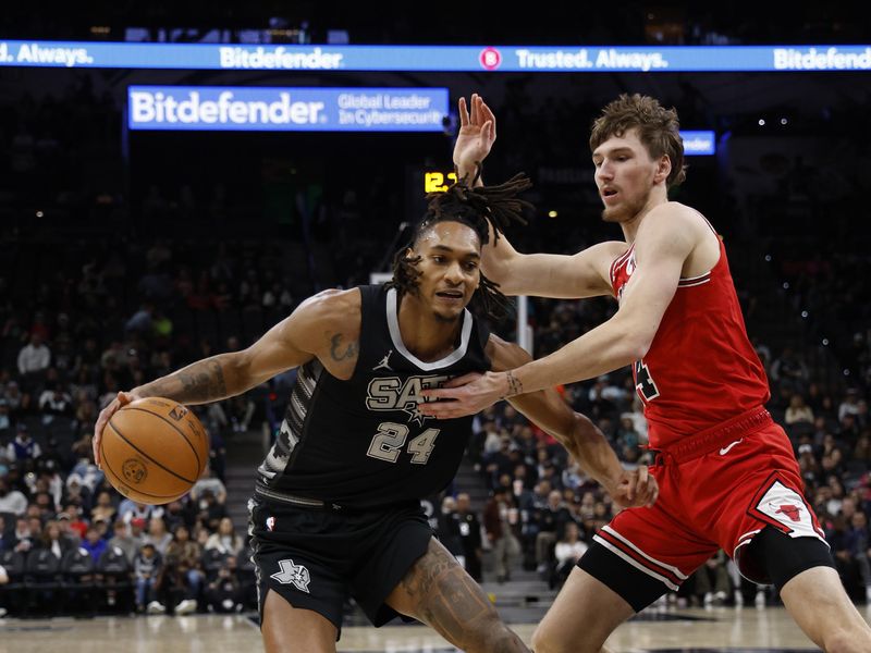 SAN ANTONIO, TX - DECEMBER 5: Devin Vassell #24 of the San Antonio Spurs drives on Matas Buzelis #14 of the Chicago Bulls in the first half at Frost Bank Center on December 5, 2024 in San Antonio, Texas. NOTE TO USER: User expressly acknowledges and agrees that, by downloading and or using this photograph, User is consenting to terms and conditions of the Getty Images License Agreement. (Photo by Ronald Cortes/Getty Images)