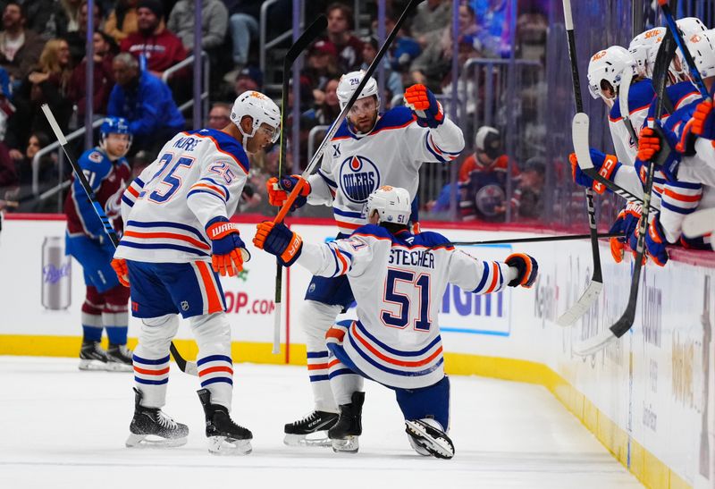 Nov 30, 2024; Denver, Colorado, USA; Edmonton Oilers defenseman Troy Stecher (51) celebrates his goal with center Leon Draisaitl (29) and defenseman Darnell Nurse (25) in the second period against the Colorado Avalanche at Ball Arena. Mandatory Credit: Ron Chenoy-Imagn Images