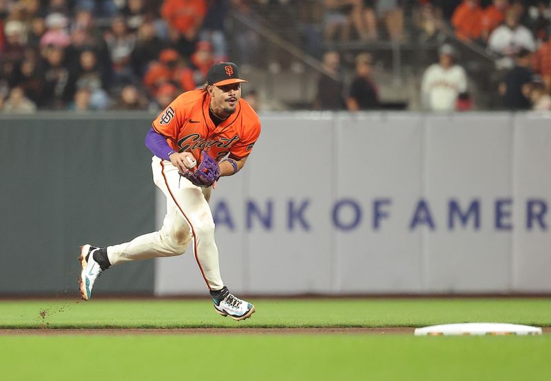 Sep 26, 2025; San Francisco, California, USA; San Francisco Giants shortstop Willy Adames (2) gathers the ball against the Colorado Rockies during the seventh inning at Oracle Park. Mandatory Credit: Kelley L Cox-Imagn Images