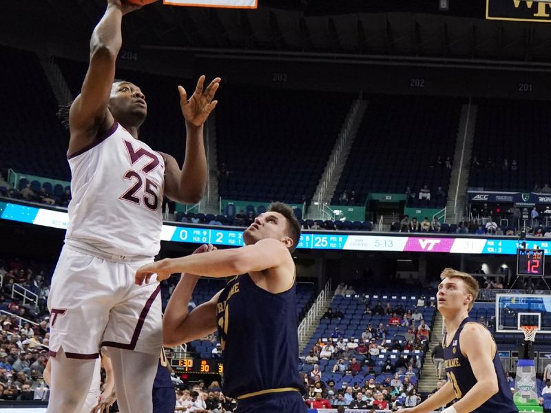 Mar 7, 2023; Greensboro, NC, USA; Virginia Tech Hokies forward Justyn Mutts (25) takes a shot over Notre Dame Fighting Irish forward Nate Laszewski (14) during the first half of the first round of the ACC tournament at Greensboro Coliseum. Mandatory Credit: John David Mercer-USA TODAY Sports