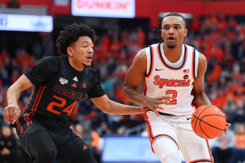 Jan 20, 2024; Syracuse, New York, USA; Syracuse Orange guard JJ Starling (2) drives to the basket as Miami (Fl) Hurricanes guard Nijel Pack (24) defends during the second half at the JMA Wireless Dome. Mandatory Credit: Rich Barnes-USA TODAY Sports