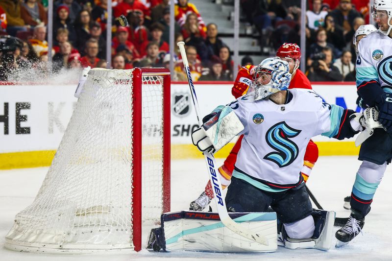 Jan 5, 2026; Calgary, Alberta, CAN; Seattle Kraken goaltender Philipp Grubauer (31) makes a save against the Calgary Flames during the second period at Scotiabank Saddledome. Mandatory Credit: Sergei Belski-Imagn Images