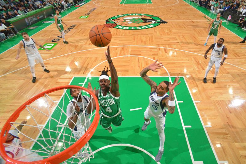 BOSTON, MA - JUNE 17: Jrue Holiday #4 of the Boston Celtics drives to the basket during the game against the Dallas Mavericks during Game 5 of the 2024 NBA Finals on June 17, 2024 at the TD Garden in Boston, Massachusetts. NOTE TO USER: User expressly acknowledges and agrees that, by downloading and or using this photograph, User is consenting to the terms and conditions of the Getty Images License Agreement. Mandatory Copyright Notice: Copyright 2024 NBAE  (Photo by Jesse D. Garrabrant/NBAE via Getty Images)