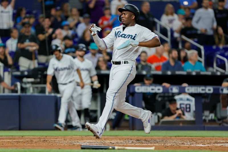 Jun 19, 2023; Miami, Florida, USA; Miami Marlins right fielder Jesus Sanchez (7) scores after an RBI single from first baseman Garrett Cooper (not pictured) against the Toronto Blue Jays during the third inning at loanDepot Park. Mandatory Credit: Sam Navarro-USA TODAY Sports