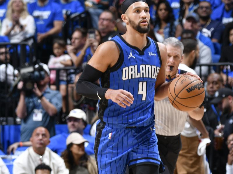 ORLANDO, FL - APRIL 25: Jalen Suggs #4 of the Orlando Magic handles the ball during the game  against the Cleveland Cavaliers during Round 1 Game 3 of the 2024 NBA Playoffs on April 25, 2024 at Kia Center in Orlando, Florida. NOTE TO USER: User expressly acknowledges and agrees that, by downloading and or using this photograph, User is consenting to the terms and conditions of the Getty Images License Agreement. Mandatory Copyright Notice: Copyright 2023 NBAE (Photo by Fernando Medina/NBAE via Getty Images)