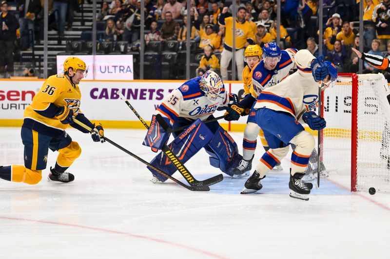 Jan 13, 2026; Nashville, Tennessee, USA;  Edmonton Oilers goaltender Tristan Jarry (35) blocks the shot of Nashville Predators left wing Cole Smith (36) during the first period at Bridgestone Arena. Mandatory Credit: Steve Roberts-Imagn Images