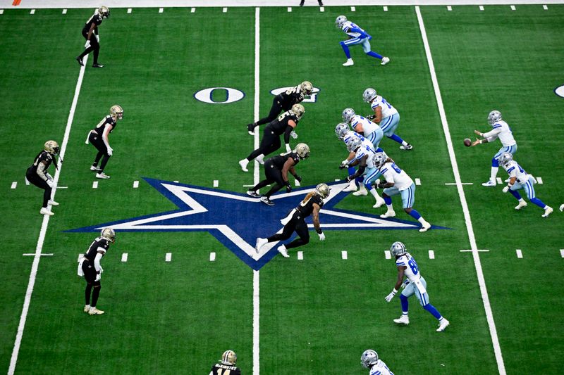 Dallas Cowboys quarterback Dak Prescott, top right, takes a snap while running a play against the New Orleans Saints during the first half of an NFL football game, Sunday, Sept. 15, 2024, in Arlington, Texas. (AP Photo/Jerome Miron)