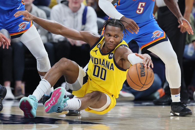 INDIANAPOLIS, INDIANA - MARCH 31:  Bennedict Mathurin #00 of the Indiana Pacers reaches for a loose ball against the Oklahoma City Thunder at Gainbridge Fieldhouse on March 31, 2023 in Indianapolis, Indiana.    NOTE TO USER: User expressly acknowledges and agrees that, by downloading and/or using this photograph, User is consenting to the terms and conditions of the Getty Images License Agreement. (Photo by Andy Lyons/Getty Images)