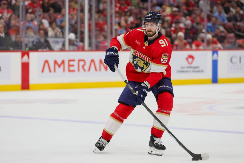 Nov 6, 2023; Sunrise, Florida, USA; Florida Panthers defenseman Oliver Ekman-Larsson (91) moves the puck against the Columbus Blue Jackets during the second period at Amerant Bank Arena. Mandatory Credit: Sam Navarro-USA TODAY Sports