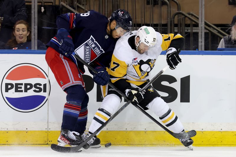 Dec 6, 2024; New York, New York, USA; New York Rangers defenseman K'Andre Miller (79) and Pittsburgh Penguins right wing Bryan Rust (17) fight for the puck during the third period at Madison Square Garden. Mandatory Credit: Brad Penner-Imagn Images