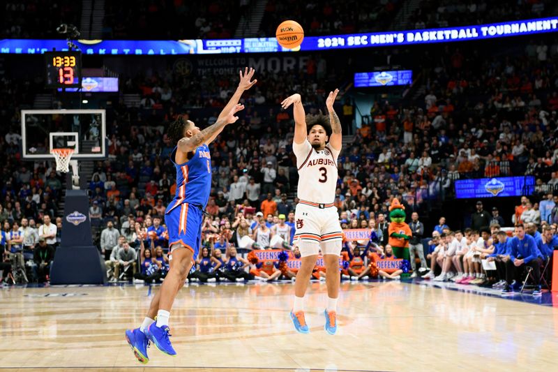 Mar 17, 2024; Nashville, TN, USA;  Auburn Tigers guard Tre Donaldson (3) shoots against Florida Gators guard Will Richard (5) in the second half in the SEC Tournament championship game at Bridgestone Arena. Mandatory Credit: Steve Roberts-USA TODAY Sports