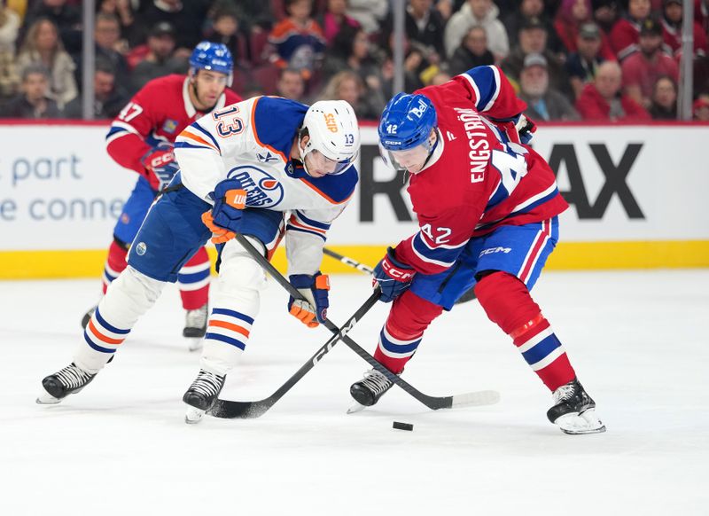 Dec 14, 2025; Montreal, Quebec, CAN; Edmonton Oilers forward Mattias Janmark (13) and Montreal Canadiens defenseman Adam Engstrom (42) battle for the puck during the first period at the Bell Centre. Mandatory Credit: Eric Bolte-Imagn Images