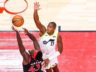 TORONTO, CANADA - DECEMBER 23:  Pascal Siakam #43 of the Toronto Raptors grabs a rebound during the game as Kris Dunn #11 of the Utah Jazz plays defense on December 23, 2023 at the Scotiabank Arena in Toronto, Ontario, Canada.  NOTE TO USER: User expressly acknowledges and agrees that, by downloading and or using this Photograph, user is consenting to the terms and conditions of the Getty Images License Agreement.  Mandatory Copyright Notice: Copyright 2023 NBAE (Photo by Vaughn Ridley/NBAE via Getty Images)