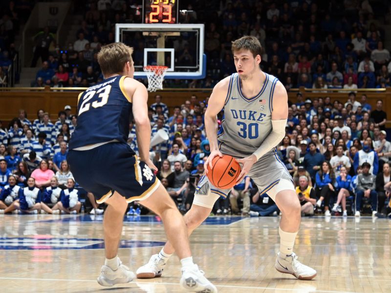 Feb 14, 2023; Durham, North Carolina, USA; Duke Blue Devils center Kyle Filipowski(30) controls the ball in front of Notre Dame Fighting Irish guard Dane Goodwin (23) during the second half at Cameron Indoor Stadium.  The Blue Devils won 68-64. Mandatory Credit: Rob Kinnan-USA TODAY Sports