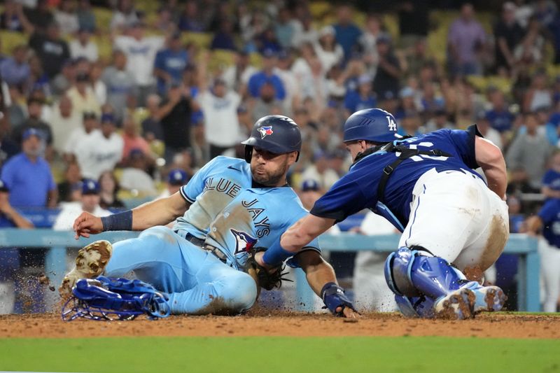 Jul 25, 2023; Los Angeles, California, USA; Los Angeles Dodgers catcher Will Smith (16) tags out Toronto Blue Jays center fielder Kevin Kiermaier (39) out at home plate in the 10th inning at Dodger Stadium. Mandatory Credit: Kirby Lee-USA TODAY Sports