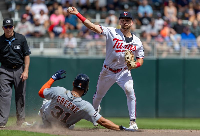 Aug 16, 2023; Minneapolis, Minnesota, USA; Minnesota Twins second baseman Edouard Julien (47) forces out Detroit Tigers center fielder Riley Greene (31) at second base and throws the ball to first base for an out in the fifth inning at Target Field. Mandatory Credit: Jesse Johnson-USA TODAY Sports