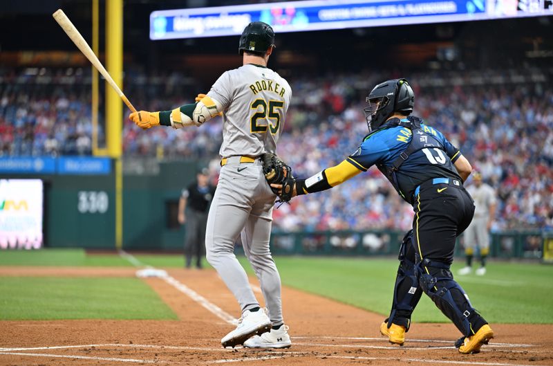 Jul 12, 2024; Philadelphia, Pennsylvania, USA; Philadelphia Phillies catcher Rafael Marchan (13) tags Oakland Athletics outfielder Brent Rooker (25) after striking out in the first inning at Citizens Bank Park. Mandatory Credit: Kyle Ross-USA TODAY Sports