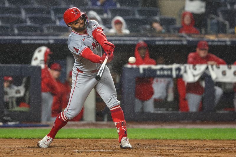 Aug 8, 2024; Bronx, New York, USA;  Los Angeles Angels left fielder Kevin Pillar (12) hits a two run single in the fifth inning against the New York Yankees at Yankee Stadium. Mandatory Credit: Wendell Cruz-USA TODAY Sports