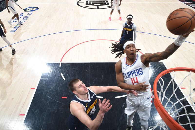 LOS ANGELES, CA - APRIL 4: Terance Mann #14 of the LA Clippers drives to the basket during the game against the Denver Nuggets on April 4, 2024 at Crypto.Com Arena in Los Angeles, California. NOTE TO USER: User expressly acknowledges and agrees that, by downloading and/or using this Photograph, user is consenting to the terms and conditions of the Getty Images License Agreement. Mandatory Copyright Notice: Copyright 2024 NBAE (Photo by Adam Pantozzi/NBAE via Getty Images)