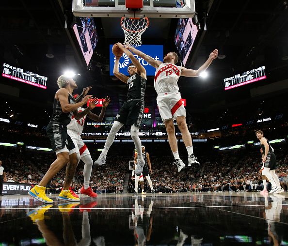 SAN ANTONIO, TX - NOVEMBER 5: Zach Collins #23 of the San Antonio Spurs battles Jakob Poeltl #19 of the Toronto Raptors for a rebound in the first half at Frost Bank Center on November  5, 2023 in San Antonio, Texas. NOTE TO USER: User expressly acknowledges and agrees that, by downloading and or using this photograph, User is consenting to terms and conditions of the Getty Images License Agreement. (Photo by Ronald Cortes/Getty Images)