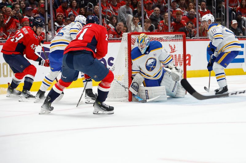 Nov 22, 2023; Washington, District of Columbia, USA; Buffalo Sabres goaltender Devon Levi (27) makes a save on Washington Capitals center Aliaksei Protas (21) in the first period at Capital One Arena. Mandatory Credit: Geoff Burke-USA TODAY Sports