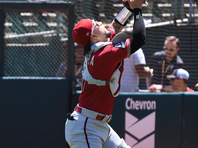 May 17, 2023; Oakland, California, USA; Arizona Diamondbacks catcher Jose Herrera (11) catches the ball against the Oakland Athletics during the second inning at Oakland-Alameda County Coliseum. Mandatory Credit: Kelley L Cox-USA TODAY Sports