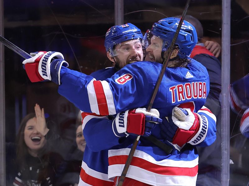 May 13, 2024; New York, New York, USA; New York Rangers defenseman Jacob Trouba (8) celebrates his short handed goal against the Carolina Hurricanes with center Barclay Goodrow (21) during the second period of game five of the second round of the 2024 Stanley Cup Playoffs at Madison Square Garden. Mandatory Credit: Brad Penner-USA TODAY Sports