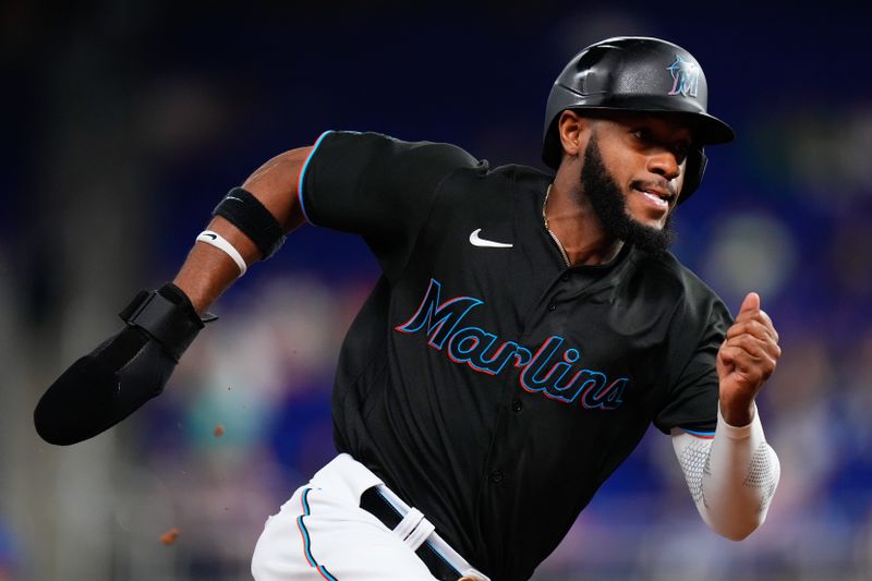 Jun 7, 2023; Miami, Florida, USA; Miami Marlins left fielder Bryan De La Cruz (14) rounds third base against the Kansas City Royals during the eighth inning at loanDepot Park. Mandatory Credit: Rich Storry-USA TODAY Sports