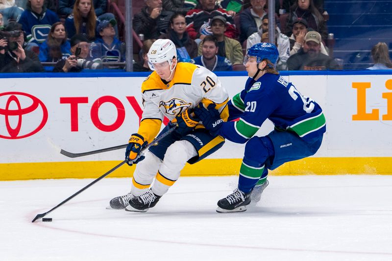 Jan 3, 2025; Vancouver, British Columbia, CAN; Vancouver Canucks forward Danton Heinen (20) checks Nashville Predators defenseman Justin Barron (20) in the second period at Rogers Arena. Mandatory Credit: Bob Frid-Imagn Images