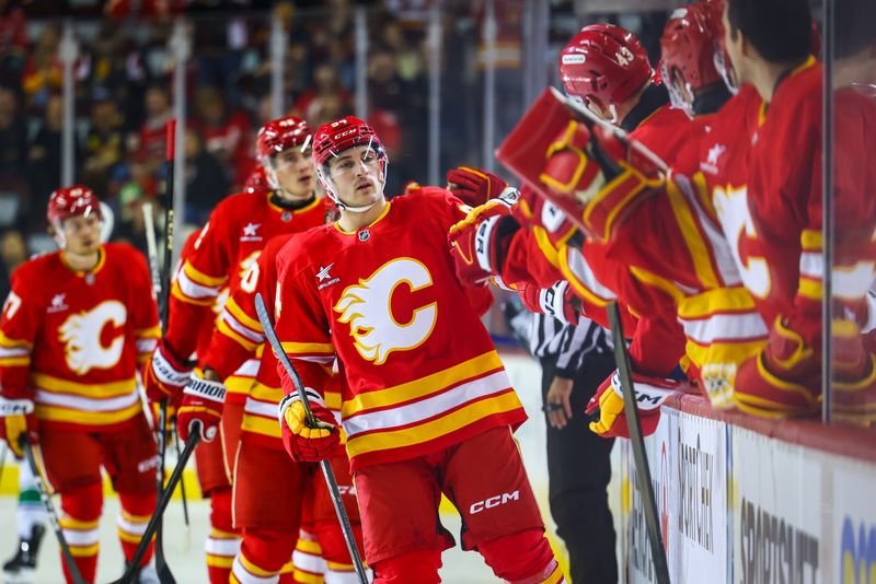 Sep 28, 2024; Calgary, Alberta, CAN; Calgary Flames defenseman Brayden Pachal (94) celebrates his goal with teammates against the Vancouver Canucks during the first period at Scotiabank Saddledome. Mandatory Credit: Sergei Belski-Imagn Images