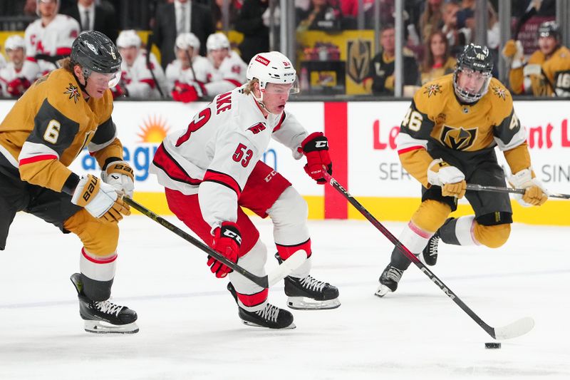 Nov 11, 2024; Las Vegas, Nevada, USA; Carolina Hurricanes right wing Jackson Blake (53) controls the puck ahead of Vegas Golden Knights defenseman Kaedan Korczak (6) during the first period at T-Mobile Arena. Mandatory Credit: Stephen R. Sylvanie-Imagn Images