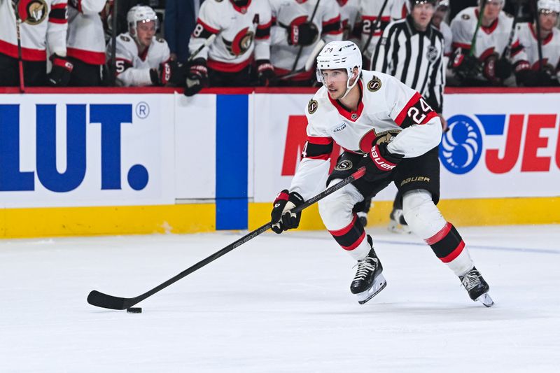 Oct 4, 2025; Montreal, Quebec, CAN; Ottawa Senators center Dylan Cozens (24) plays the puck against the Montreal Canadiens during the second period at Bell Centre. Mandatory Credit: David Kirouac-Imagn Images