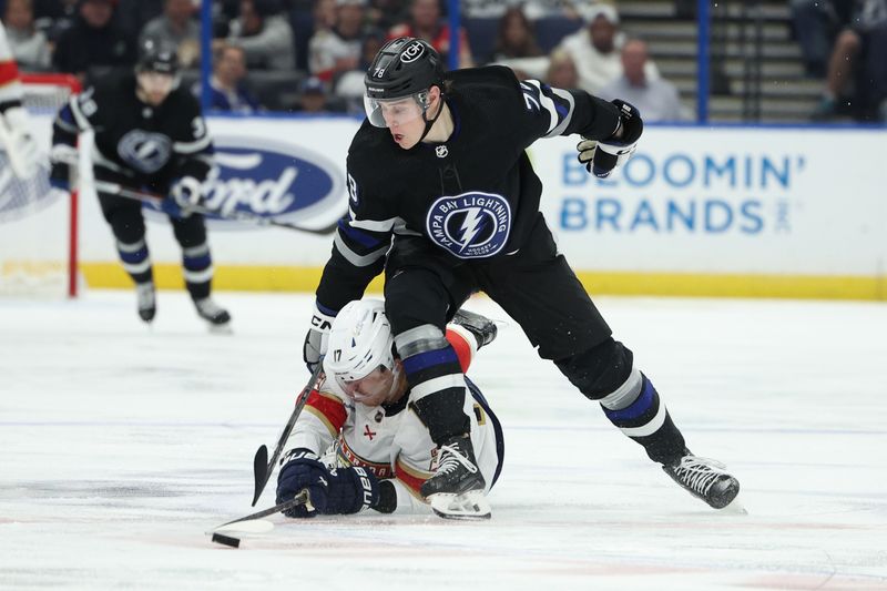 Feb 17, 2024; Tampa, Florida, USA;  Florida Panthers center Evan Rodrigues (17) and Tampa Bay Lightning defenseman Emil Martinsen Lilleberg (78) battle for the puck in the second period at Amalie Arena. Mandatory Credit: Nathan Ray Seebeck-USA TODAY Sports