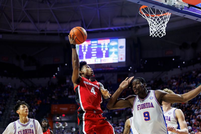 Jan 6, 2026; Gainesville, Florida, USA; Georgia Bulldogs guard Marcus Millender (4) shoots the ball over Florida Gators center Rueben Chinyelu (9) during the first half at Exactech Arena at the Stephen C. O'Connell Center. Mandatory Credit: Morgan Tencza-Imagn Images