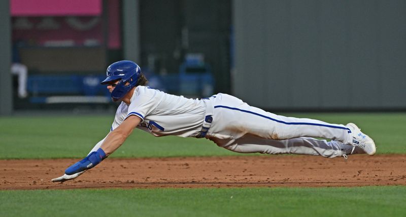 Jul 29, 2023; Kansas City, Missouri, USA;  Kansas City Royals shortstop Bobby Witt Jr. (7) dives into second base during the sixth inning against the Minnesota Twins at Kauffman Stadium. Mandatory Credit: Peter Aiken-USA TODAY Sports