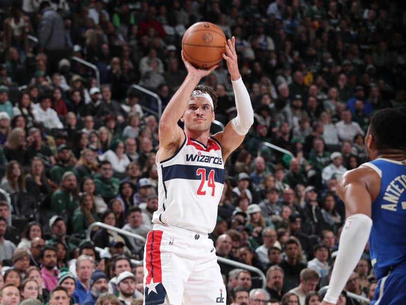 MILWAUKEE, WI - NOVEMBER 30: Corey Kispert #24 of the Washington Wizards shoots a three point basket during the game against the Milwaukee Bucks on November 30, 2024 at Fiserv Forum Center in Milwaukee, Wisconsin. NOTE TO USER: User expressly acknowledges and agrees that, by downloading and or using this Photograph, user is consenting to the terms and conditions of the Getty Images License Agreement. Mandatory Copyright Notice: Copyright 2024 NBAE (Photo by Gary Dineen/NBAE via Getty Images).