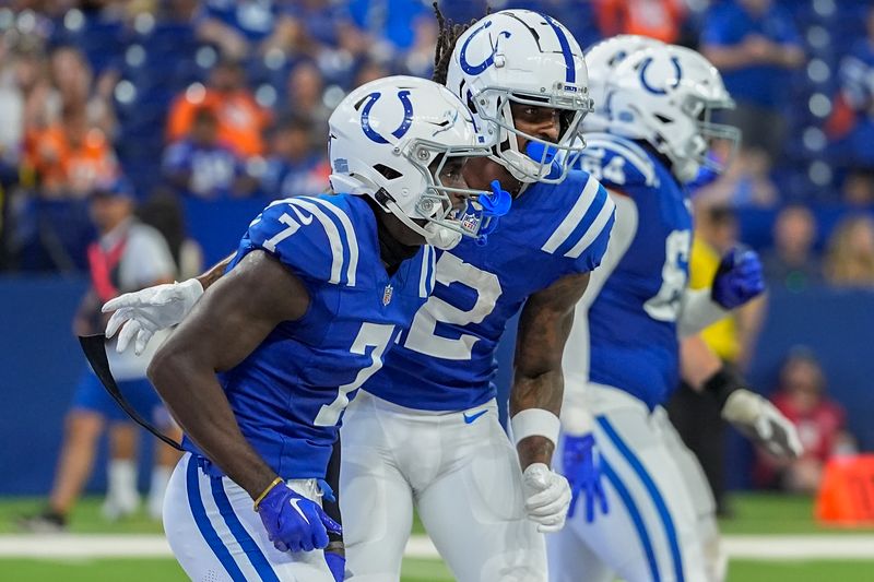 Indianapolis Colts wide receiver Laquon Treadwell (7) celebrates with wide receiver Tyrie Cleveland (12) after scoring a touchdown against the Denver Broncos during the fourth quarter of a preseason NFL football game, Sunday, Aug. 11, 2024, in Westfield, Ind. (AP Photo/Darron Cummings)