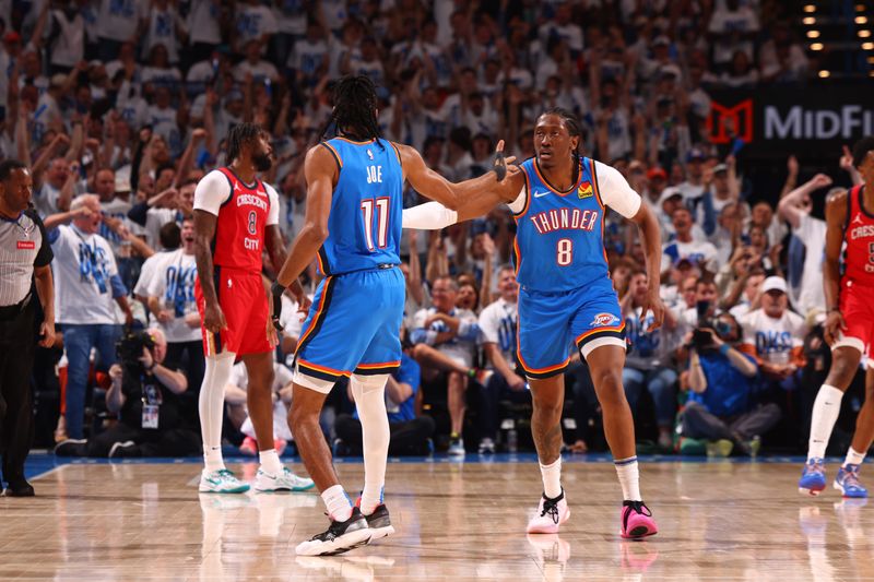 OKLAHOMA CITY, OK - APRIL 24: Jalen Williams #8 and Isaiah Joe #11 of the Oklahoma City Thunder high five during the game against the New Orleans Pelicans during Round 1 Game 2 of the 2024 NBA Playoffs on April 24, 2024 at Paycom Arena in Oklahoma City, Oklahoma. NOTE TO USER: User expressly acknowledges and agrees that, by downloading and or using this photograph, User is consenting to the terms and conditions of the Getty Images License Agreement. Mandatory Copyright Notice: Copyright 2024 NBAE (Photo by Zach Beeker/NBAE via Getty Images)