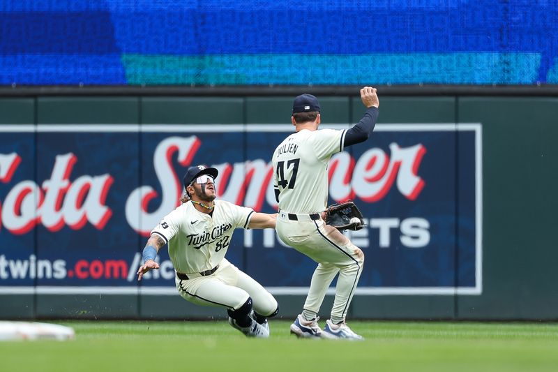 May 9, 2024; Minneapolis, Minnesota, USA; Minnesota Twins center fielder Austin Martin (82) and second baseman Edouard Julien (47) attempt to field the ball hit by Seattle Mariners Mitch Haniger (17) during the second inning at Target Field. Mandatory Credit: Matt Krohn-USA TODAY Sports