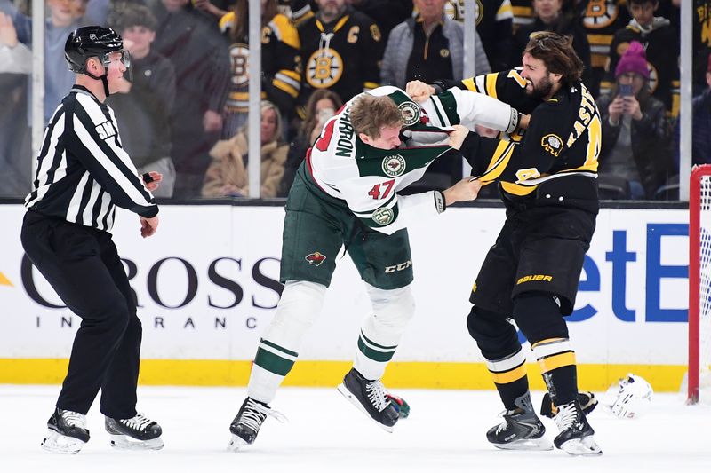 Mar 28, 2026; Boston, Massachusetts, USA; Boston Bruins center Mark Kastelic (47) fights with Minnesota Wild center Michael McCarron (47) during the first period at TD Garden. Mandatory Credit: Bob DeChiara-Imagn Images
